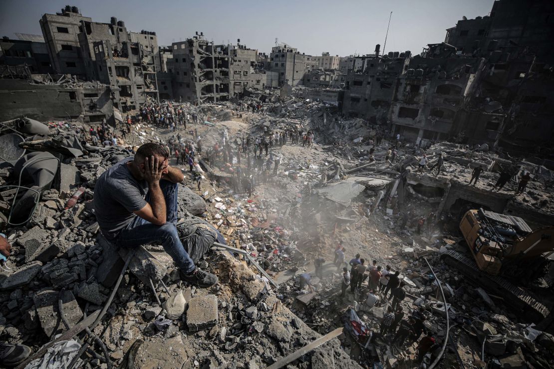 Displaced individuals in Gaza surrounded by destruction
